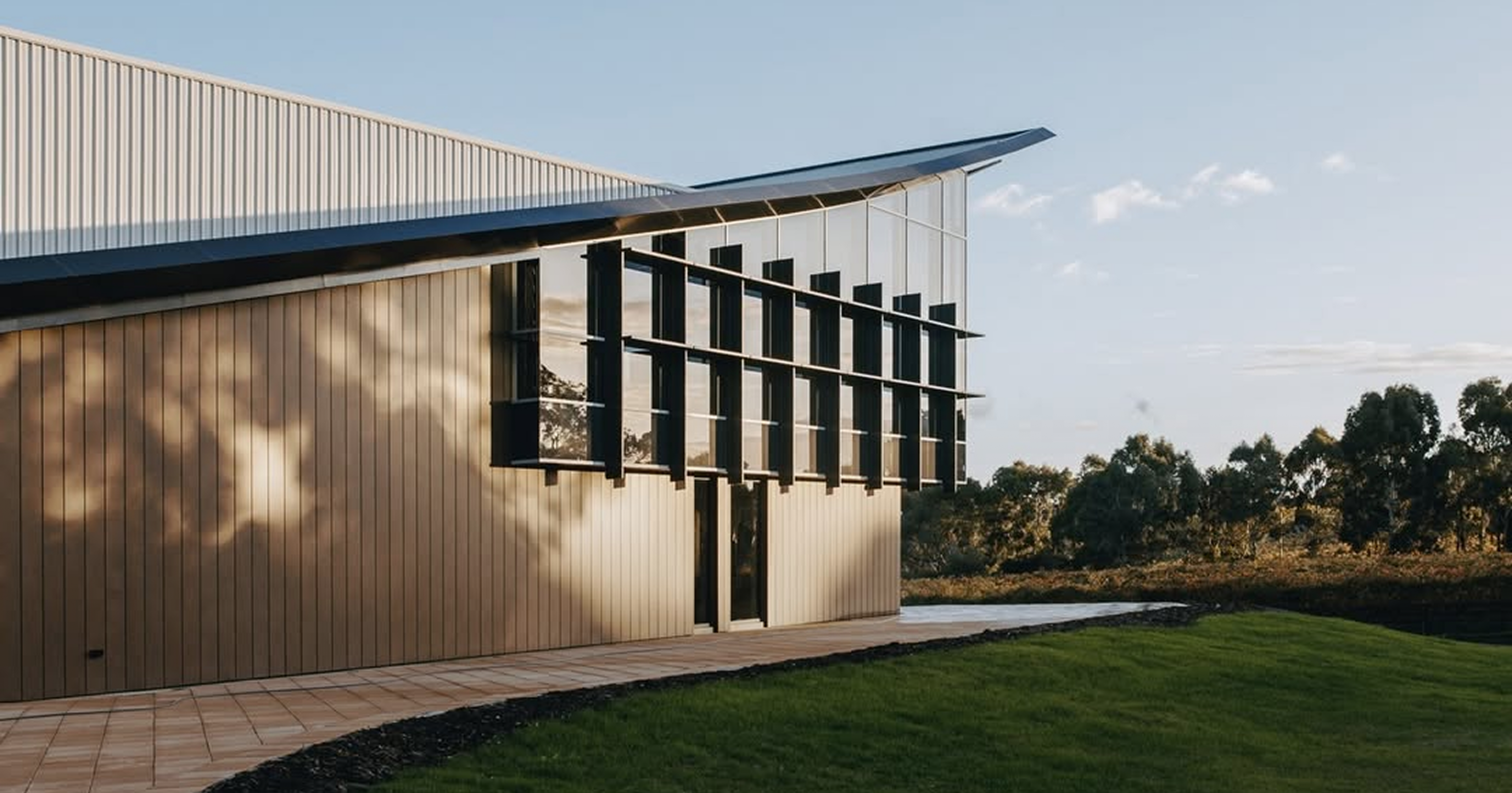 Yangarra Modern building with a flat roof and large windows, surrounded by greenery.